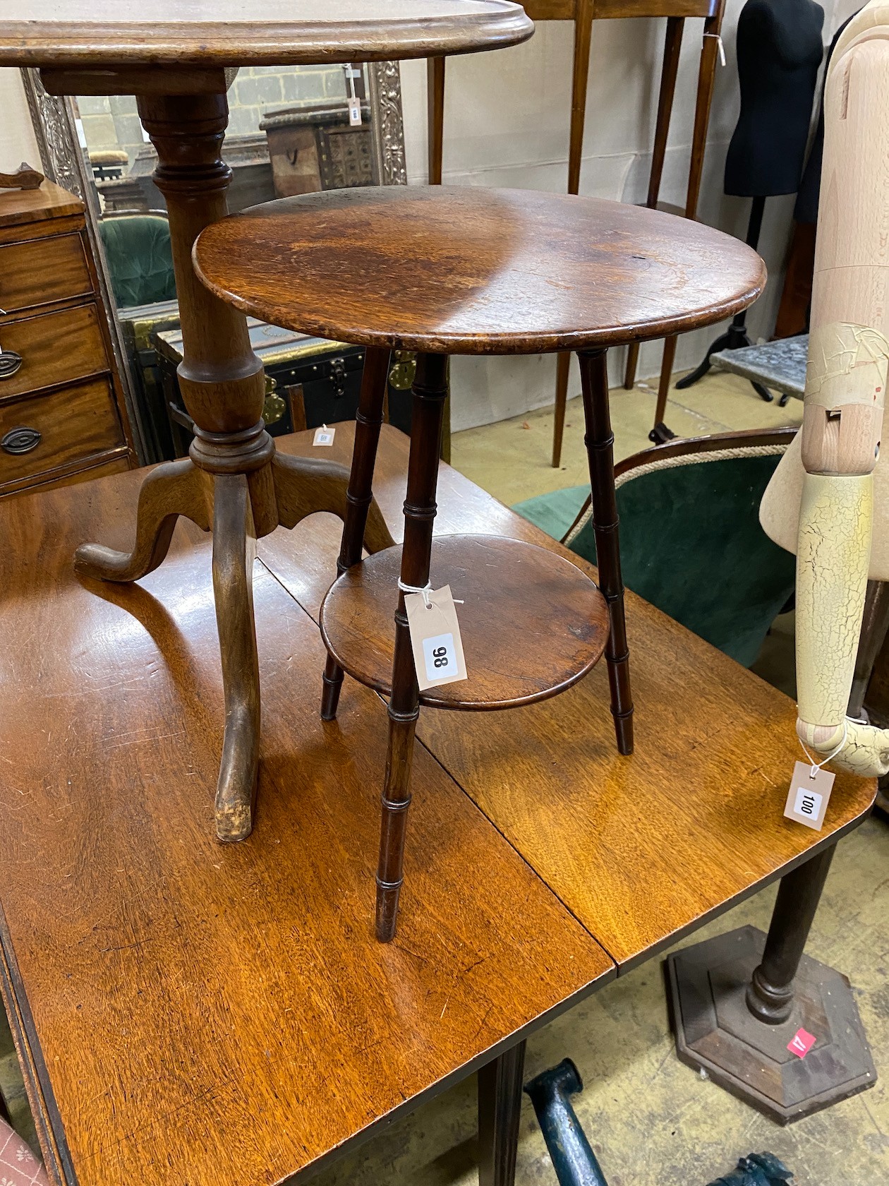 A George III circular mahogany tripod tea table, height 69cm together with a Victorian faux bamboo circular two tier occasional table